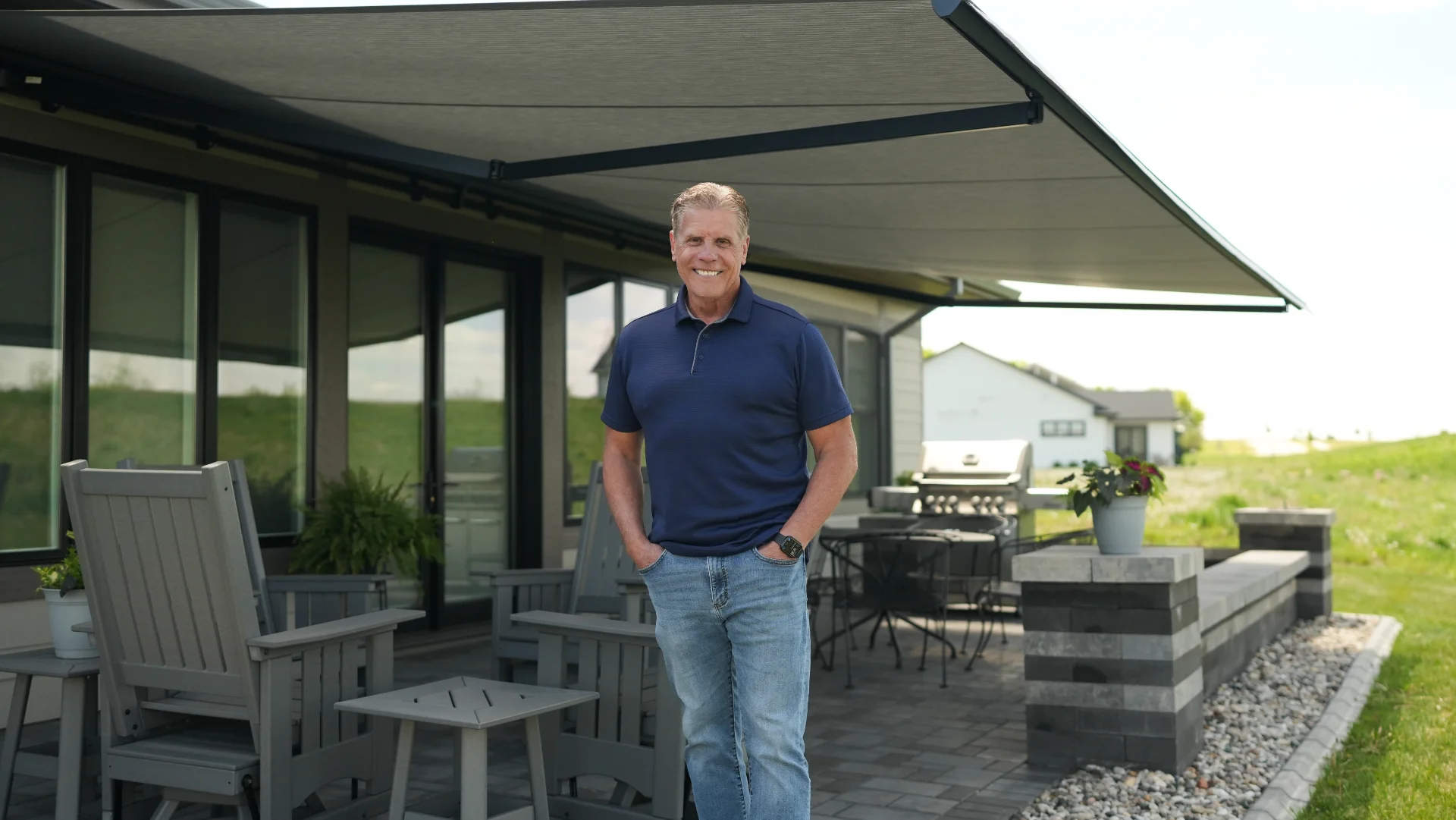 A wide Sunesta retractable awning fully extended over a residential patio in the Twin Cities metro