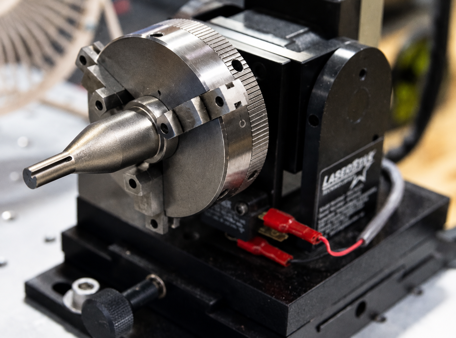 3D-printed extrusion tooling fixture with rotary indexing head mounted on a machine base