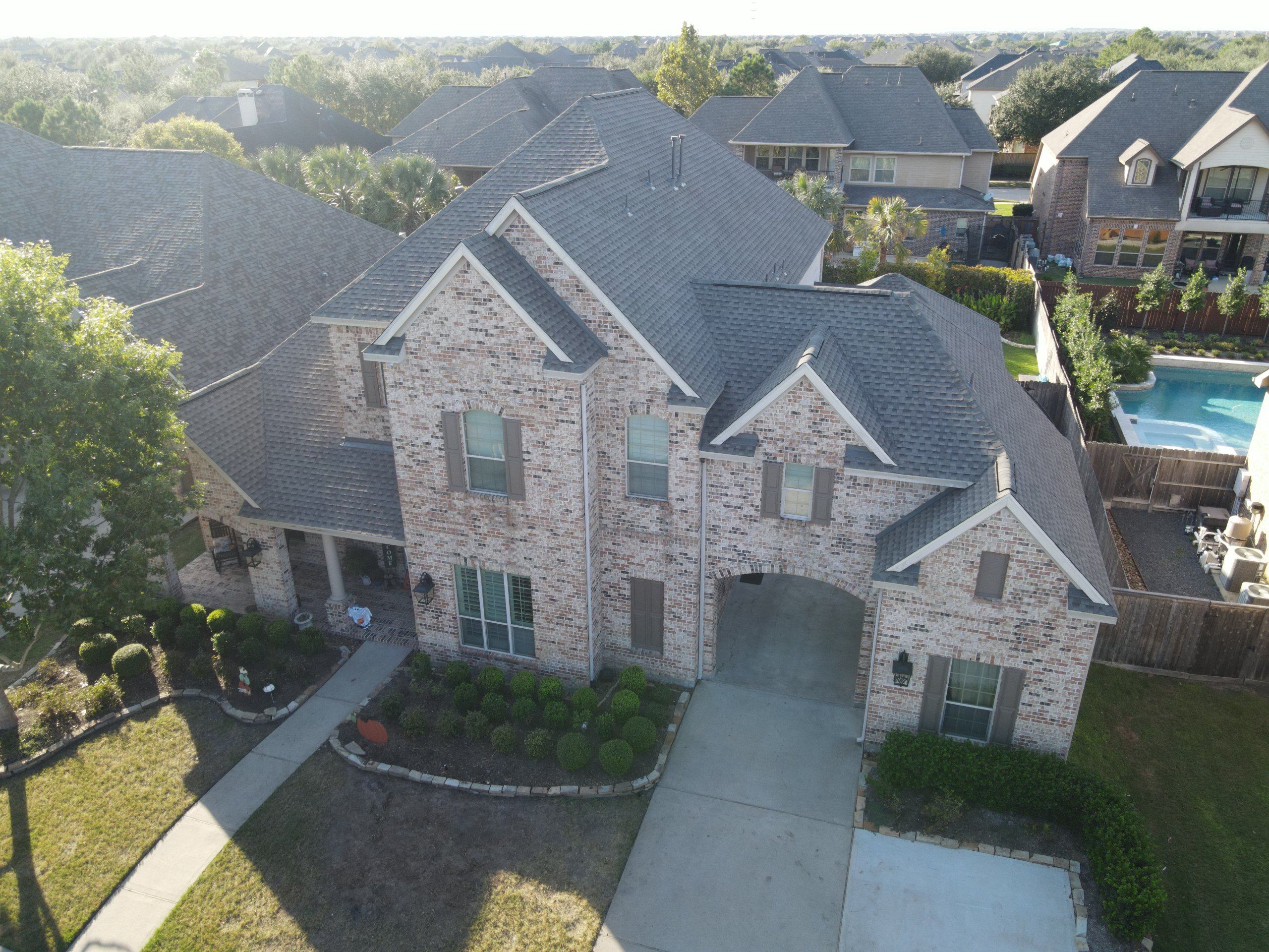 Aerial view of an insurance-approved roof replacement in progress in Katy, TX.