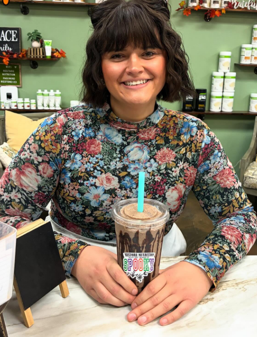 Customer holding a drink at Restore Nutrition in Plymouth, MN