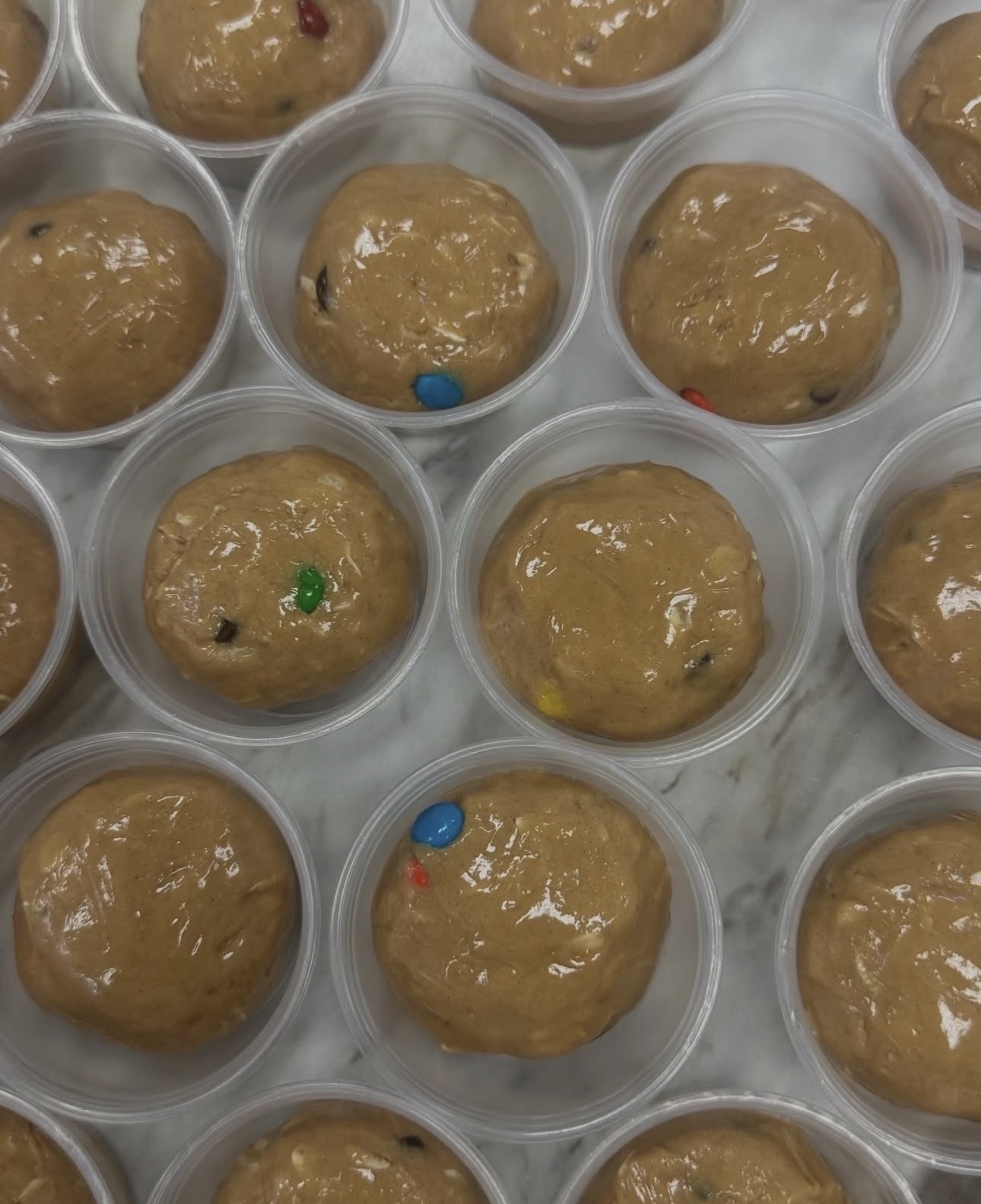 A tray of Monster Cookie protein balls rolled in oats and chocolate chips
