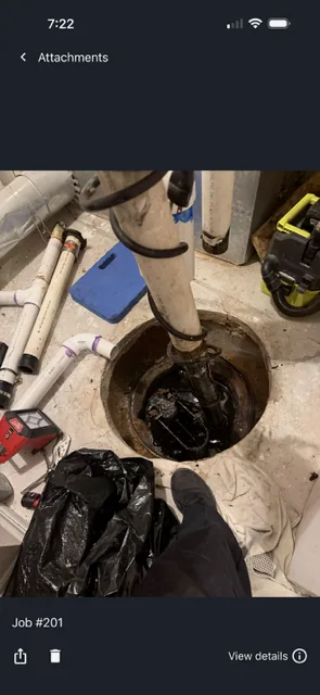 Old sewage ejector pump being removed from the pit