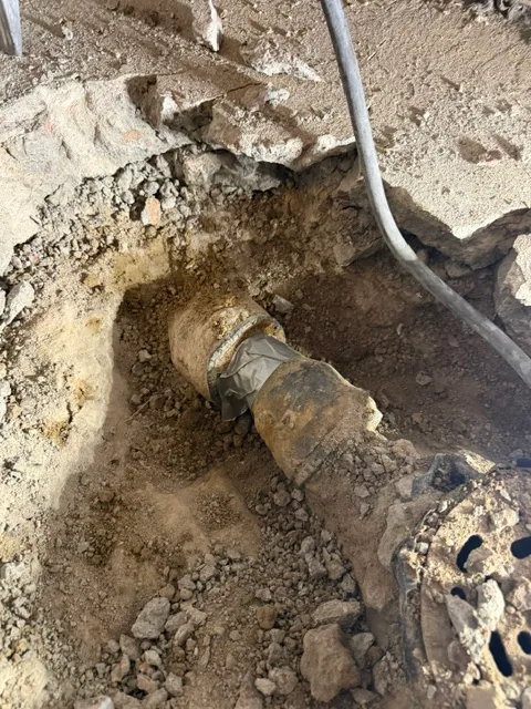 Rotted cast iron floor drain pipe before replacement