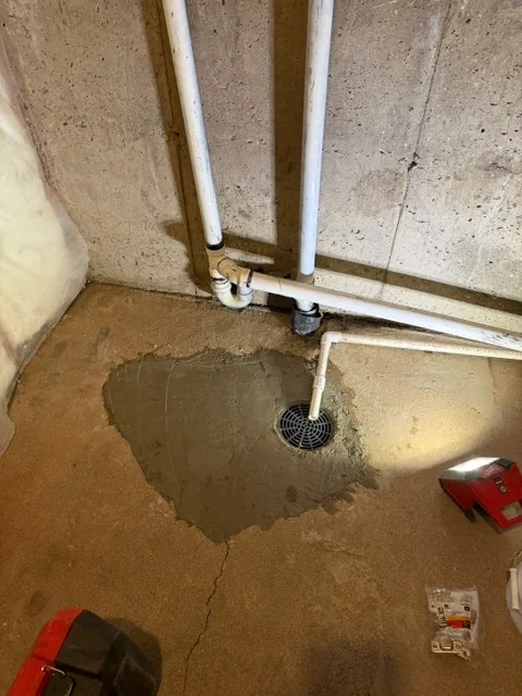 New PVC floor drain installed in place of rotted cast iron