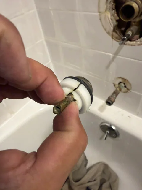 Broken grommet on stainless steel ball of shower valve