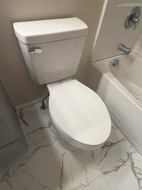 New white elongated comfort height toilet installed