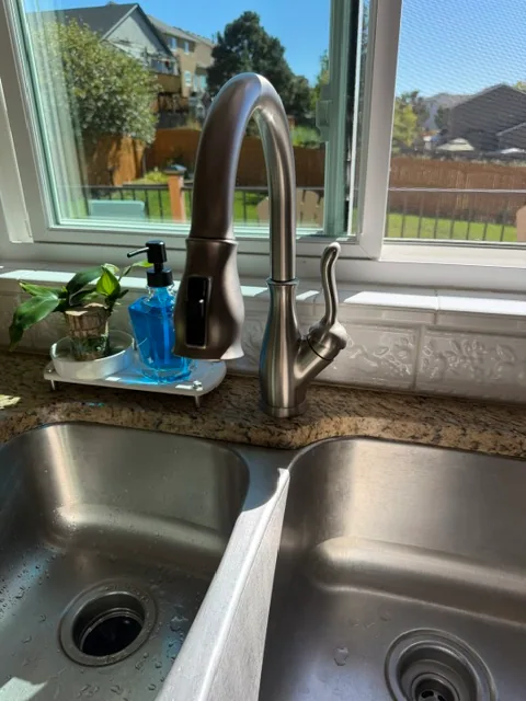 New brushed nickel Delta faucet installed on kitchen sink