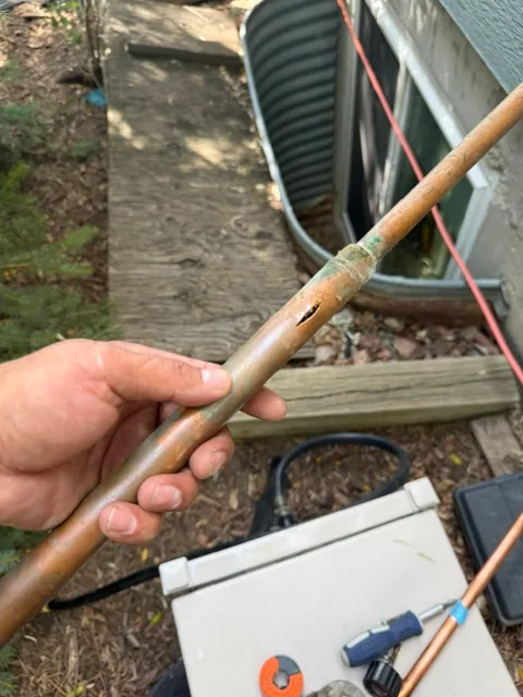 Freeze split on copper pipe behind outside hose bib