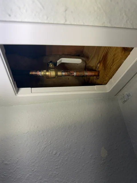 Access panel installed in ceiling to reach hose bib isolation valve