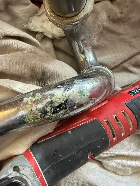 Close-up of rusted and leaking P-trap from oxidation