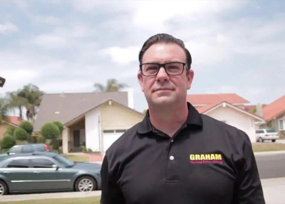 Graham Plumbing & Drain Cleaning owner on a residential street