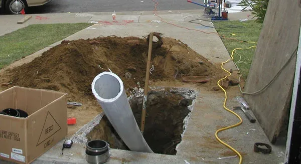 Sewer line replacement in an open trench