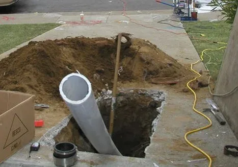 New pipe going into an excavated trench