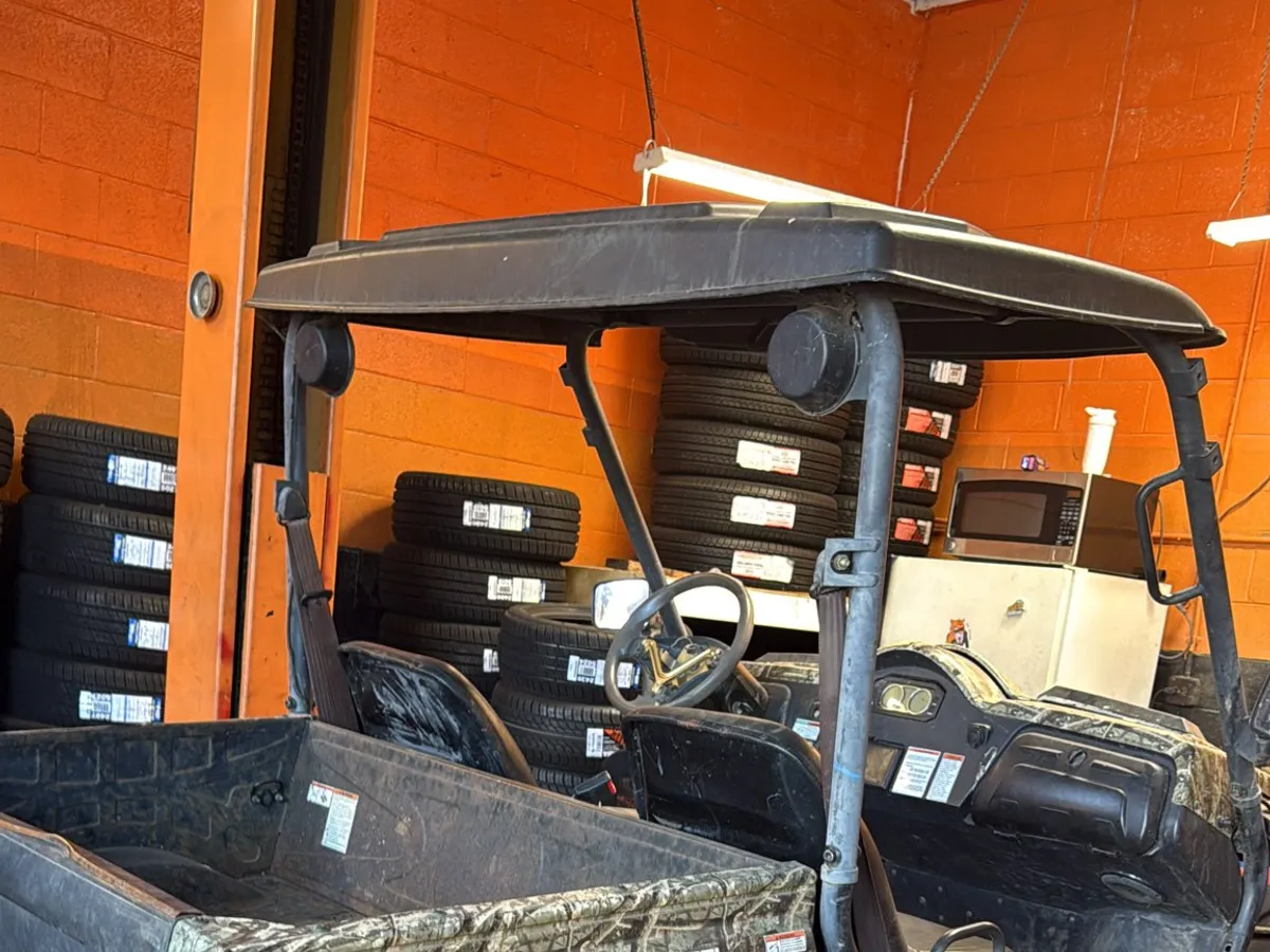 Utility vehicle up on the lift in the shop