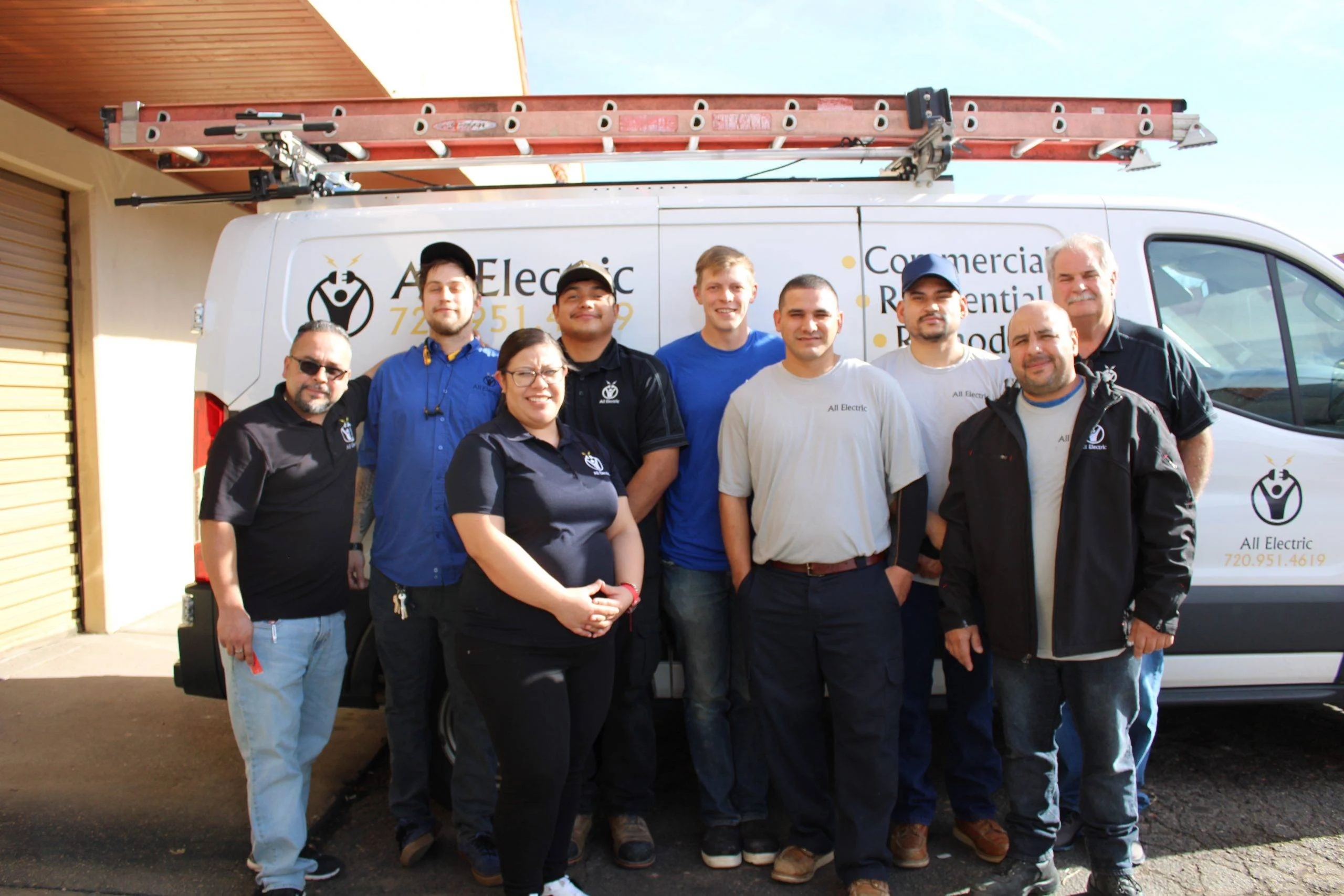 All Electric service team in front of a company van, ready to work in the Denver metro area.