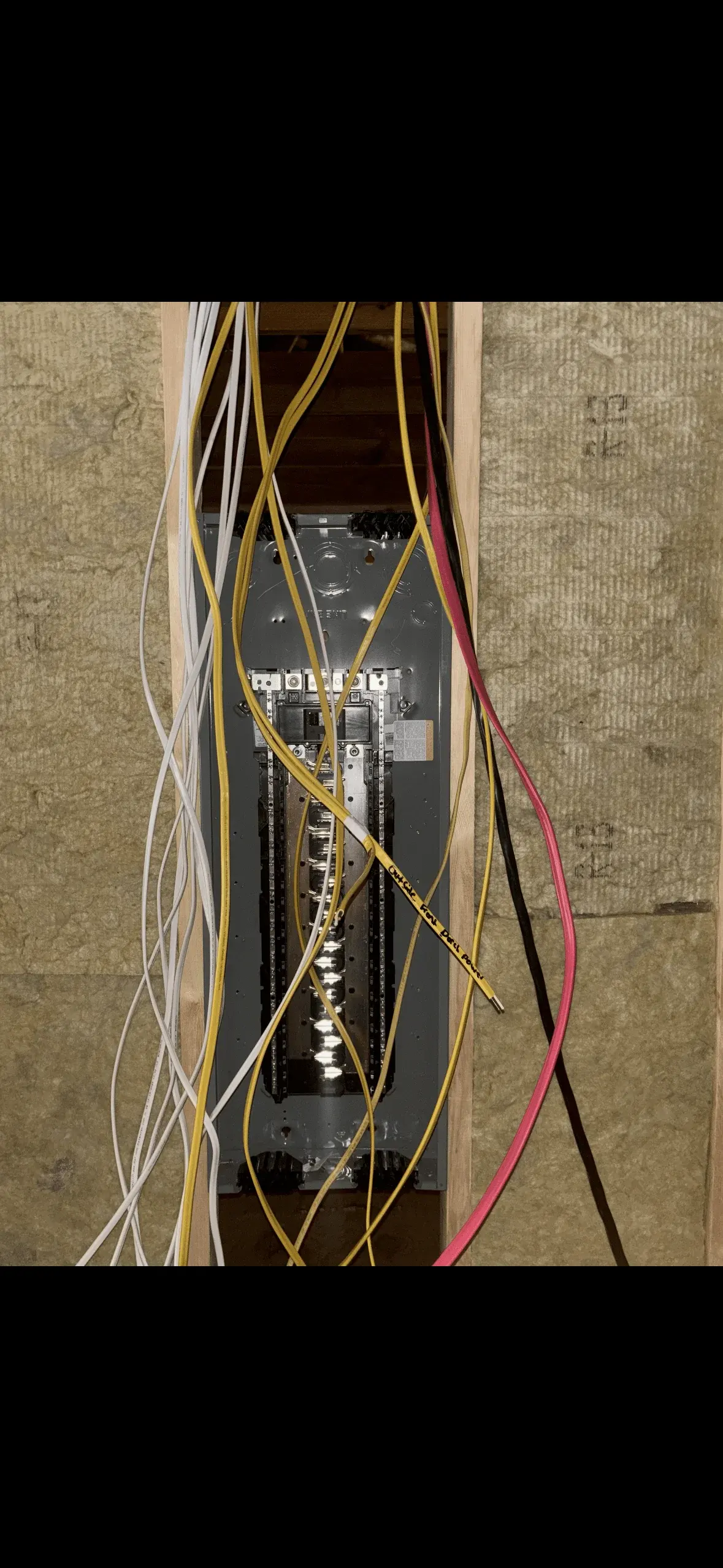 Electrical panel wiring and circuit breaker installation in an in-wall residential installation.