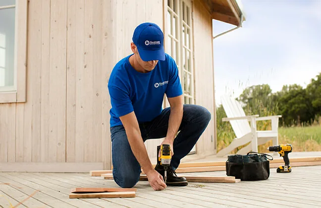 Craftsman fastening deck boards with a drill