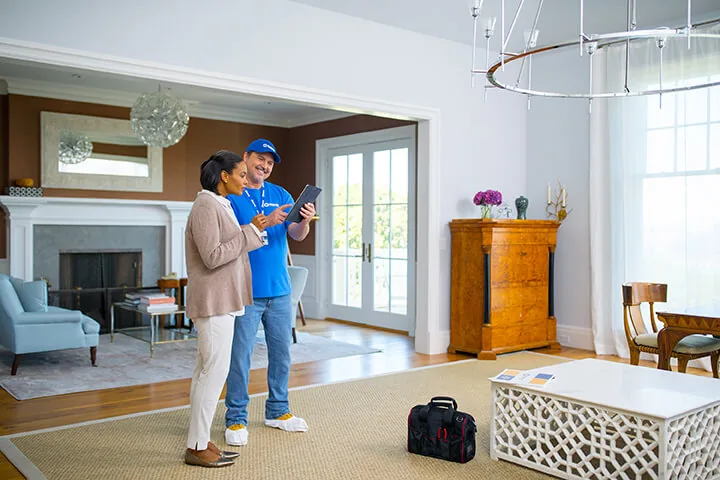 Craftsman going over a project with a homeowner in her living room