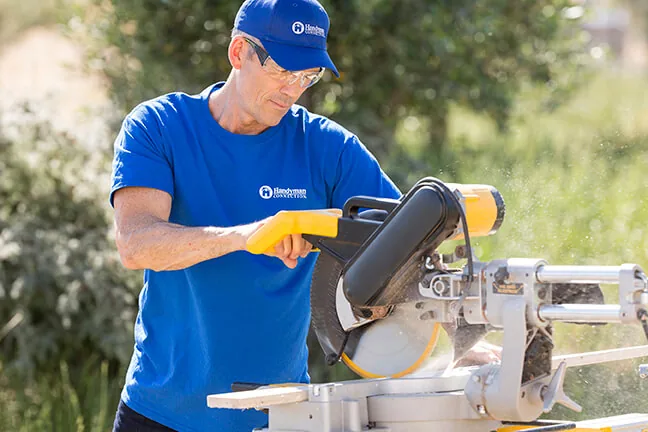 Craftsman cutting trim on a miter saw
