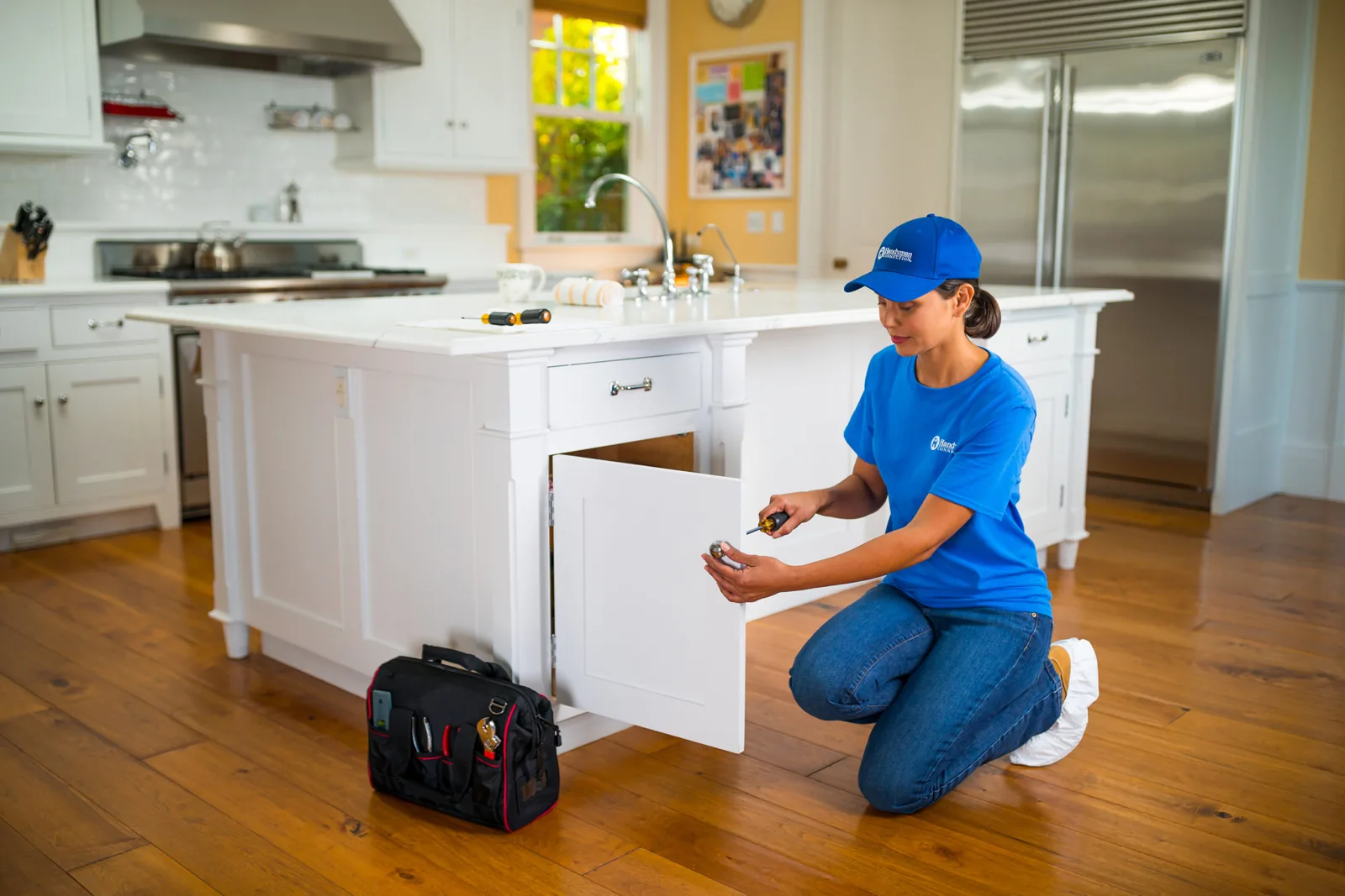 Craftswoman adjusting a drawer on a kitchen island
