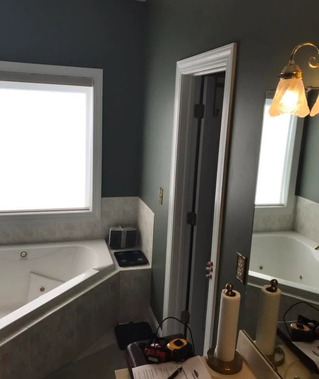 Bathroom remodel with dual vanities, custom lighting, and updated finishes in a modern master bath.