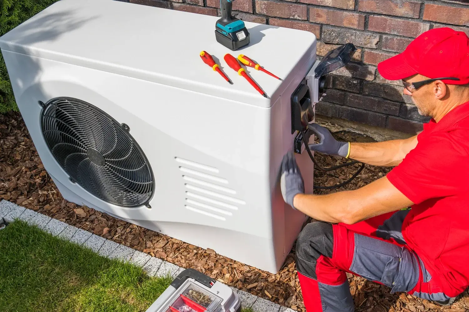 Technician servicing a heat pump
