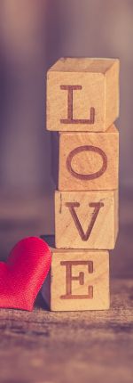 Wooden blocks stacked to spell love - premarital counselor