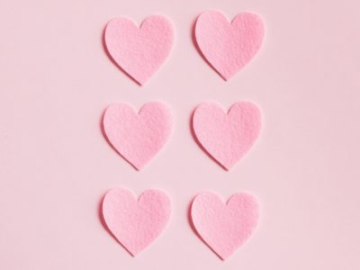 Pink paper hearts arranged on soft background - premarital counseling Minneapolis