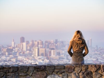 Woman looking out over city from scenic overlook - virtual premarital counseling