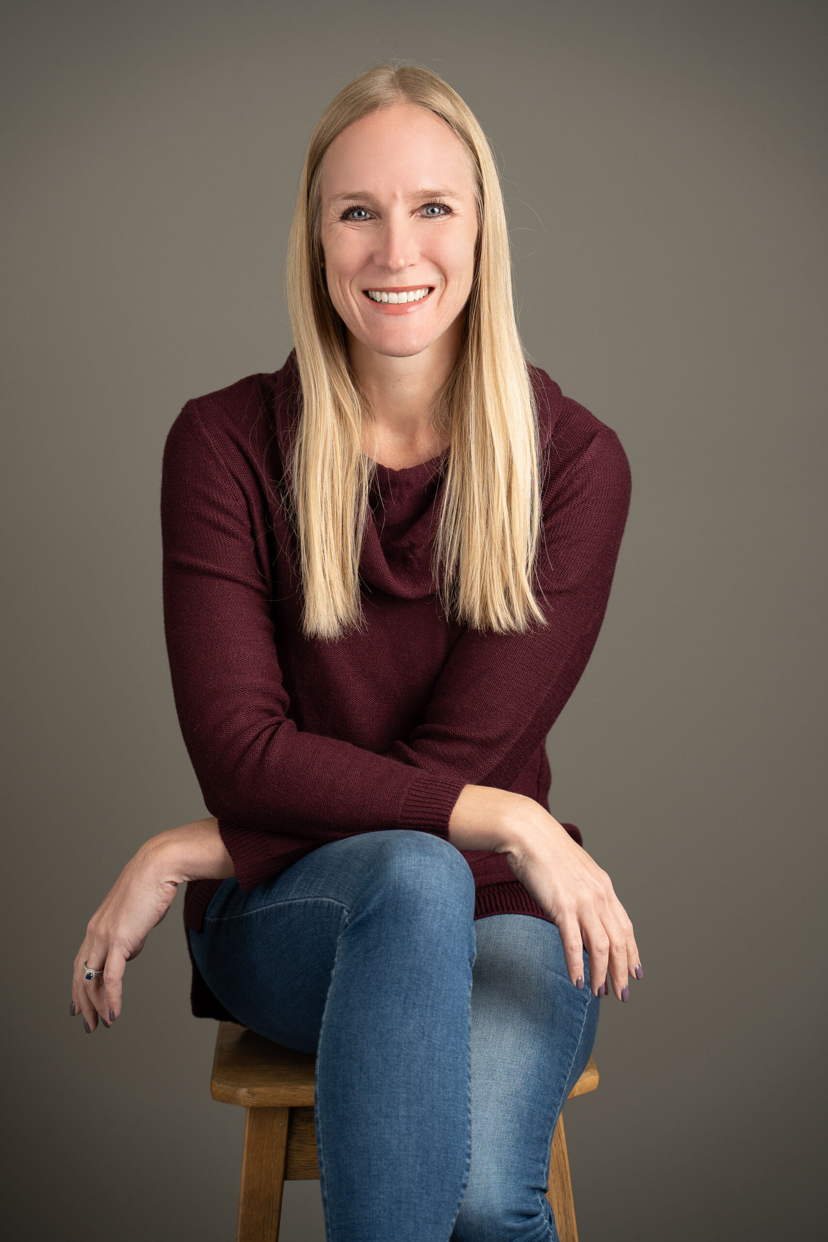 Woman seated indoors smiling during portrait session - relationship counseling for couples