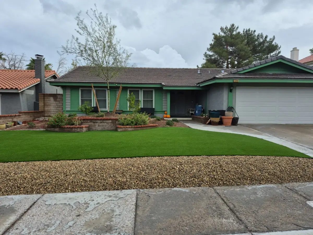 Newly installed sod lawn with fresh landscaping in a residential front yard.