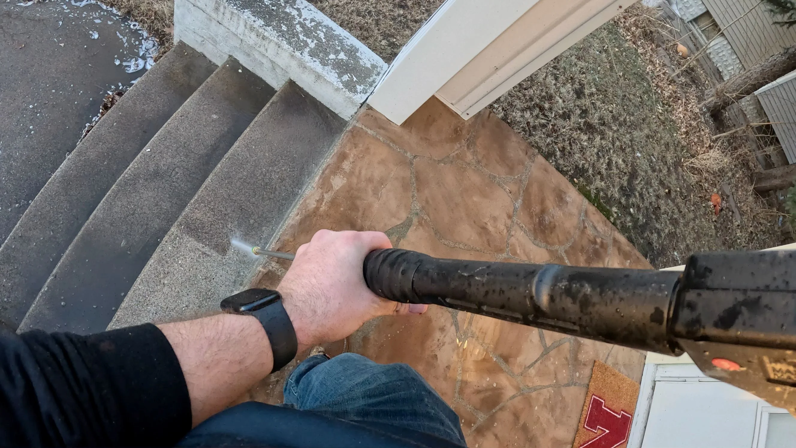Fence pressure washing service in progress on a residential property in Papillion Nebraska restoring weathered wood