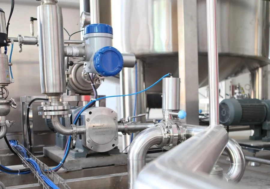 Industrial pump and piping system with blue pressure gauge and control valves in a commercial mechanical facility.