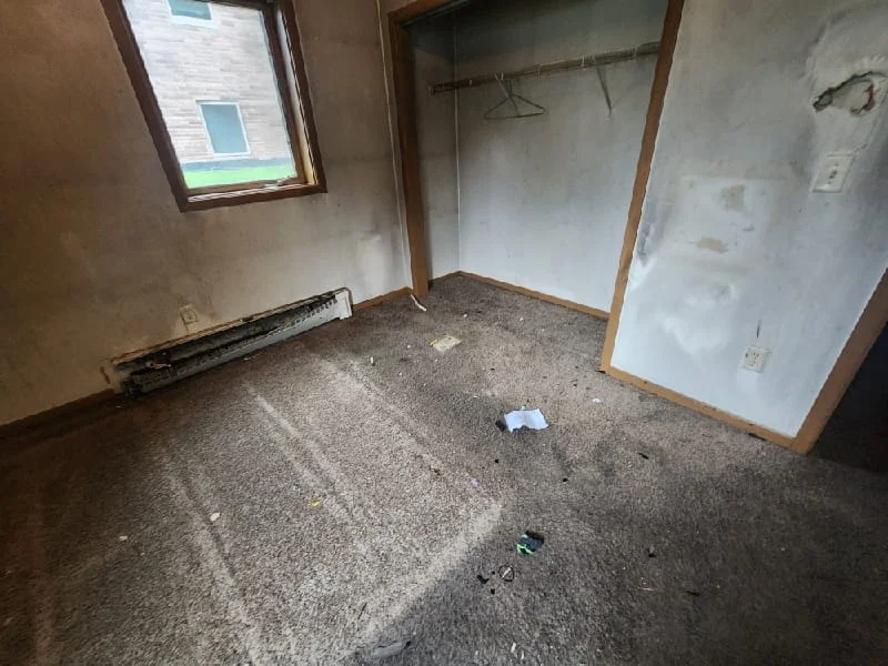 An empty residential room cleared of junk and debris during a junk removal service project.