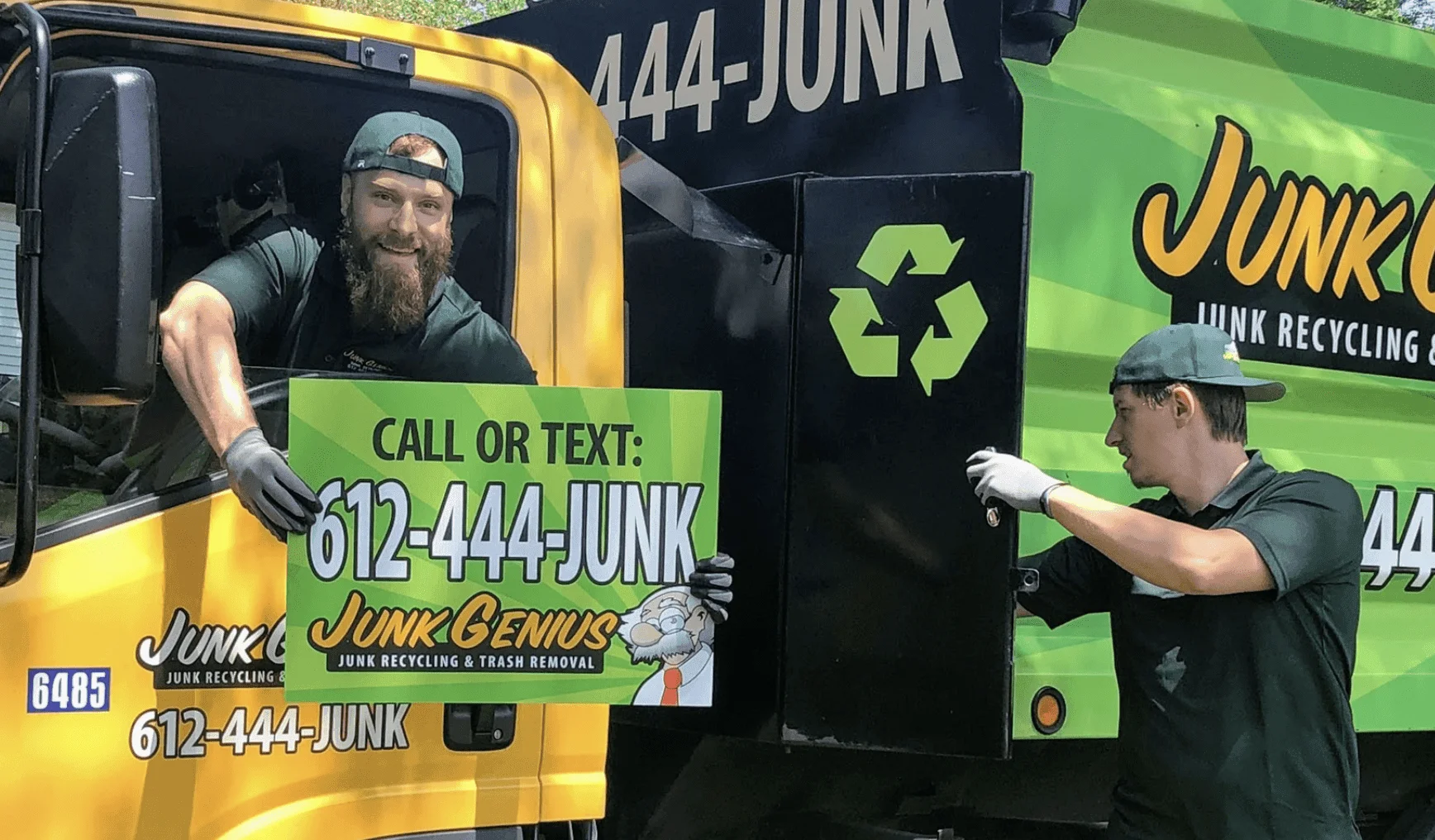 Junk removal service in progress with two workers loading trash into a yellow and green branded truck on a residential street.
