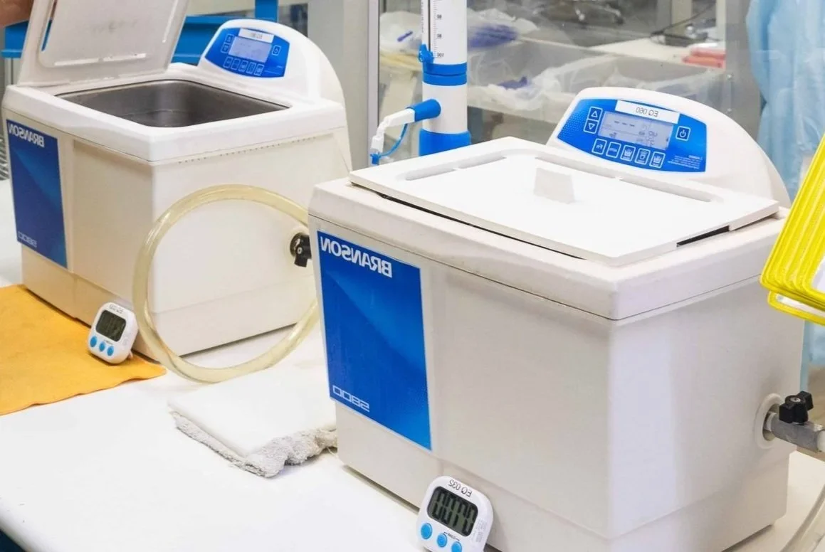 Laboratory ultrasonic cleaning equipment and water bath systems displayed in a scientific showroom or service center