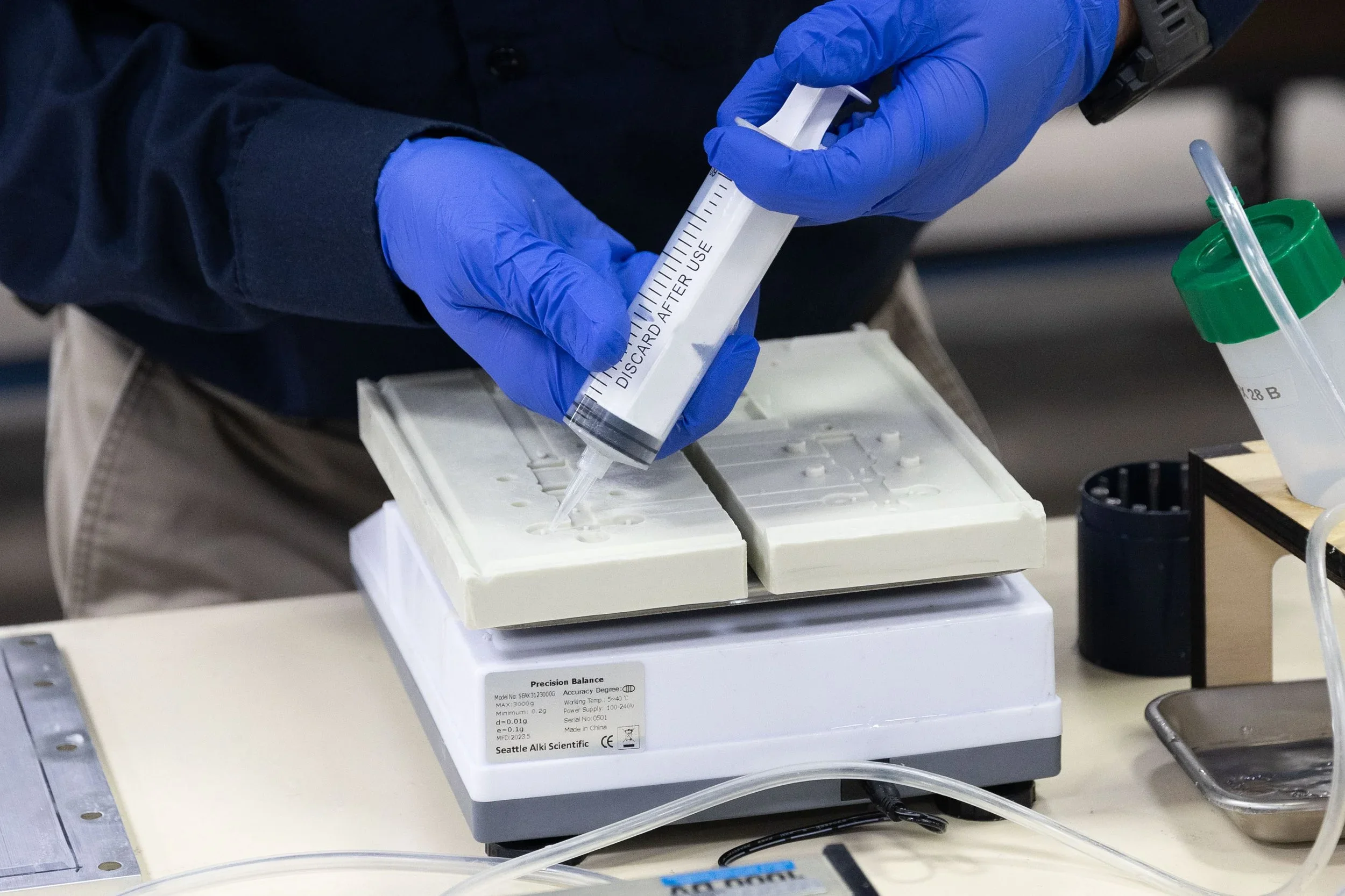 A precision balance scale being used for laboratory measurement in a scientific research setting.