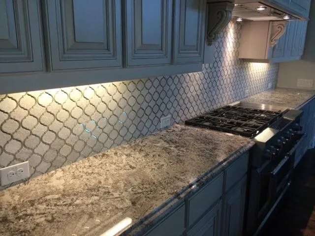 Arabesque tile backsplash under dark cabinets