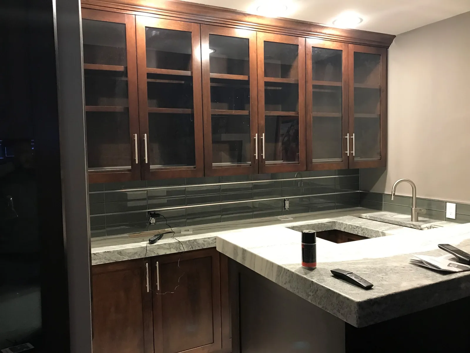 Wet bar with glass-front cabinets