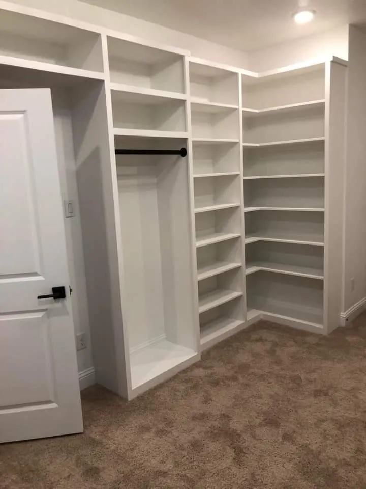 White closet system with shelves and hanging rods