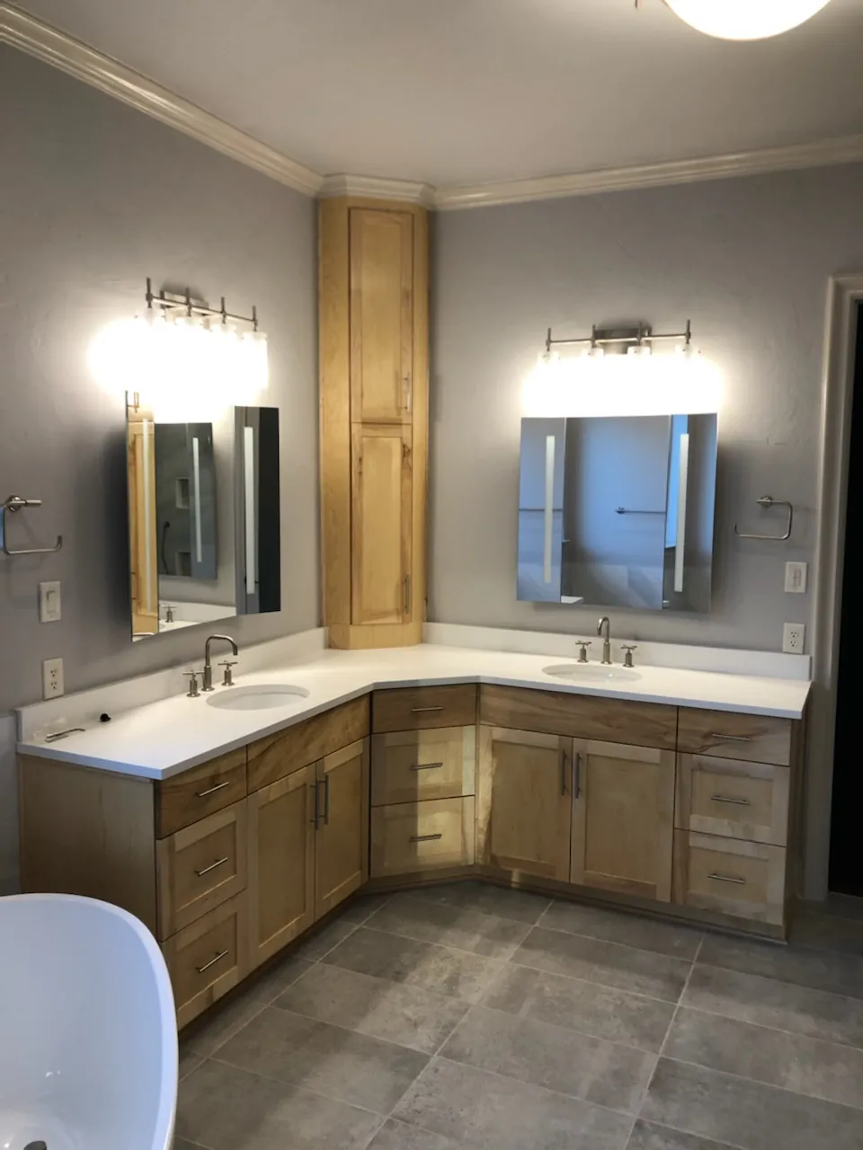 Corner double vanity with tall linen cabinet