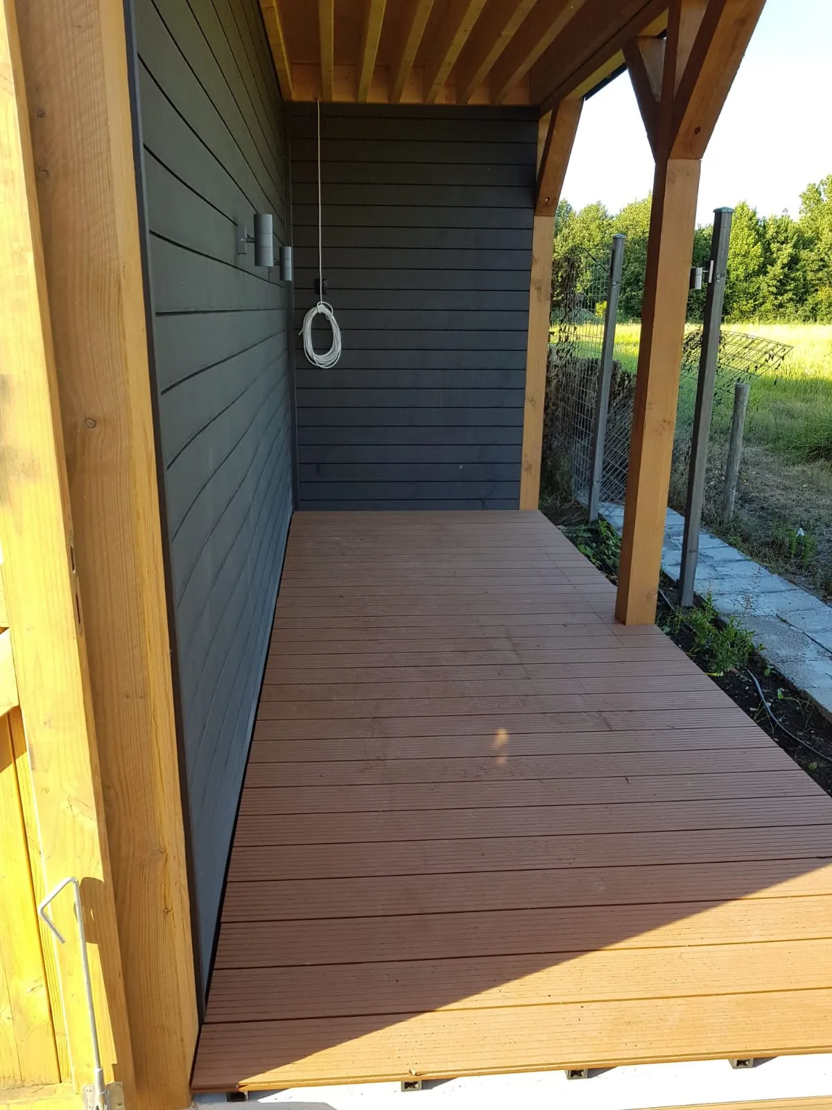Covered patio deck with a painted wall