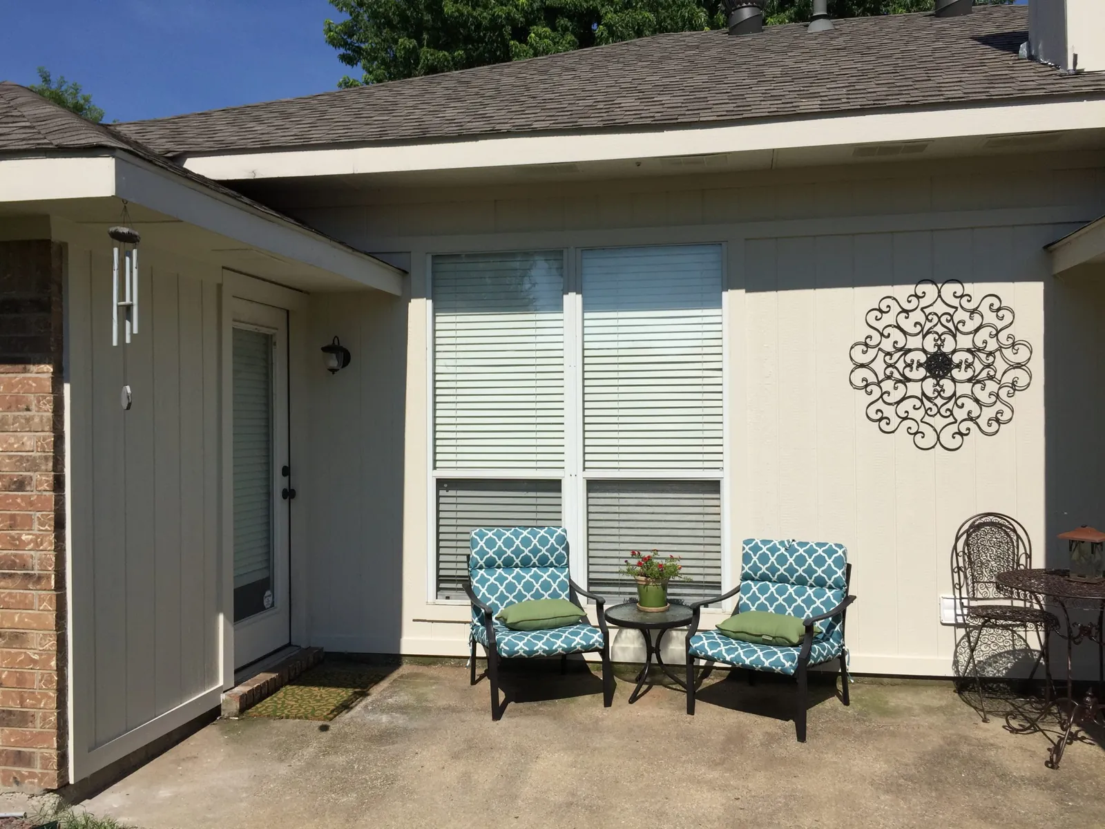 Painted exterior siding over a small patio