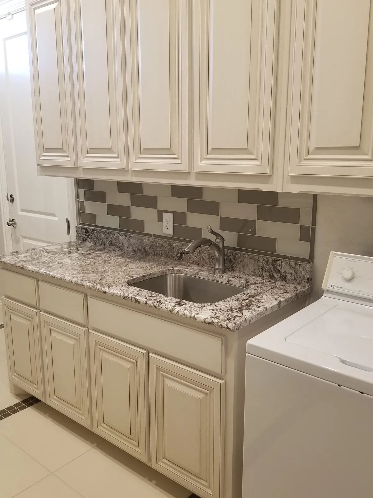 Laundry sink with a new tile backsplash