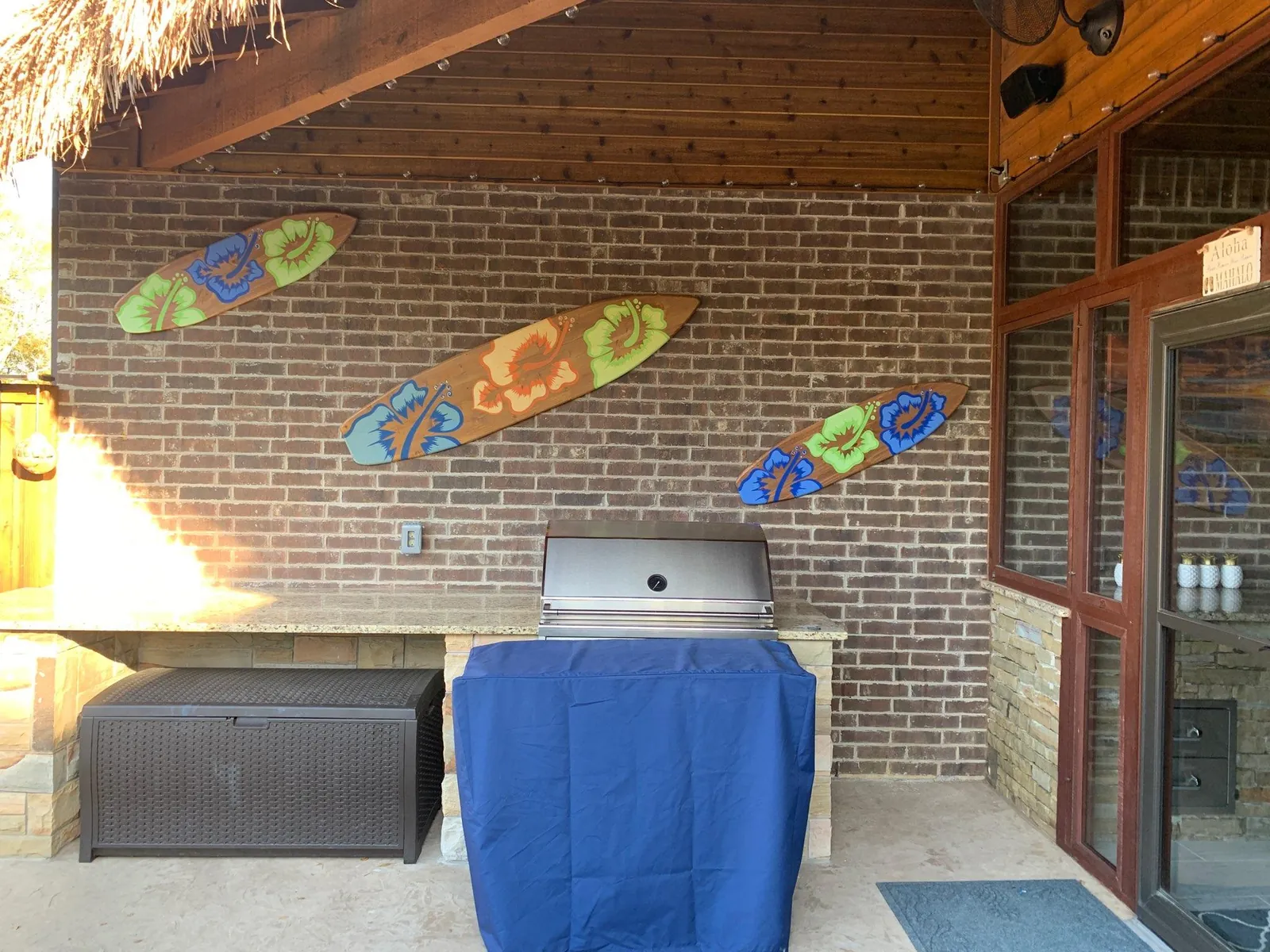 Patio wall with mounted decor over an outdoor grill