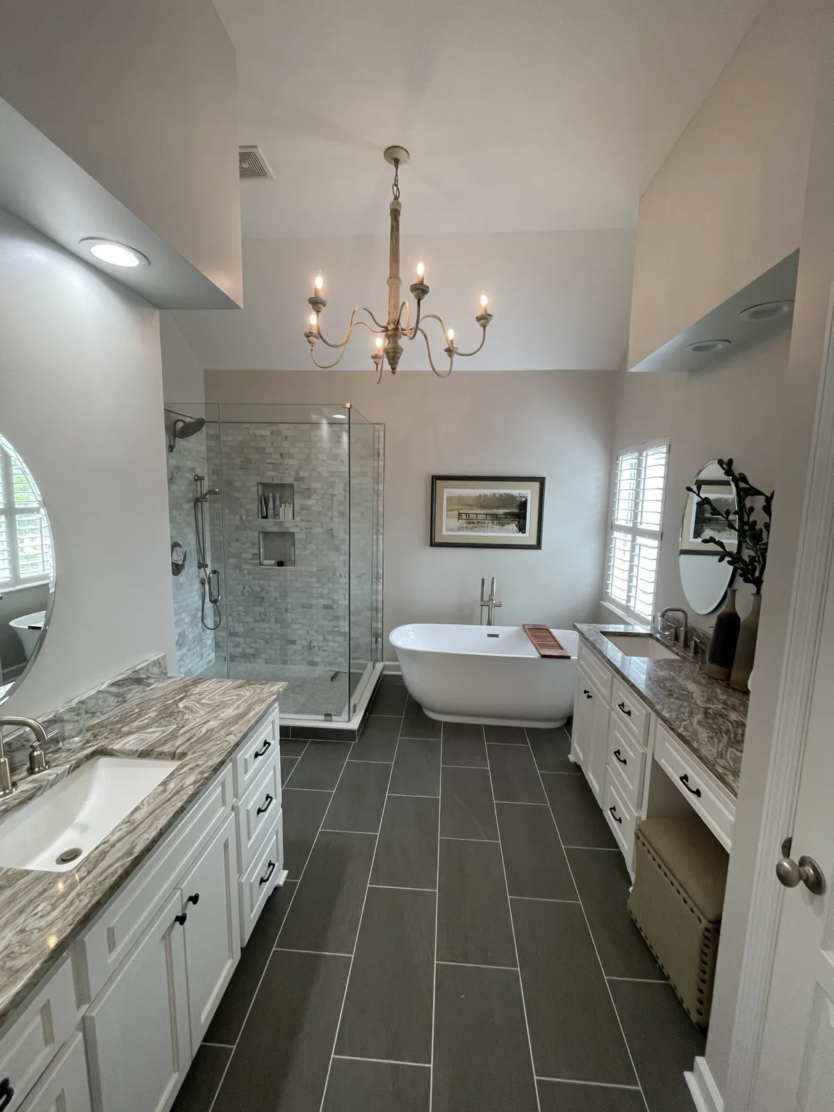 Remodeled primary bathroom with freestanding tub and glass shower