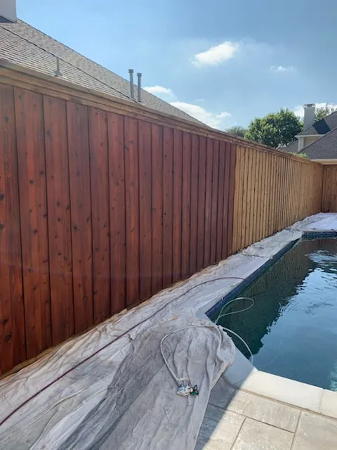 Stained cedar fence beside a pool