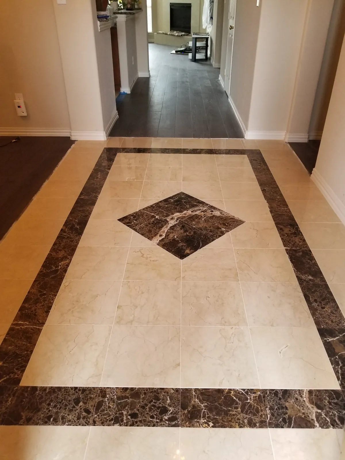 Custom tiled foyer with a marble inlay