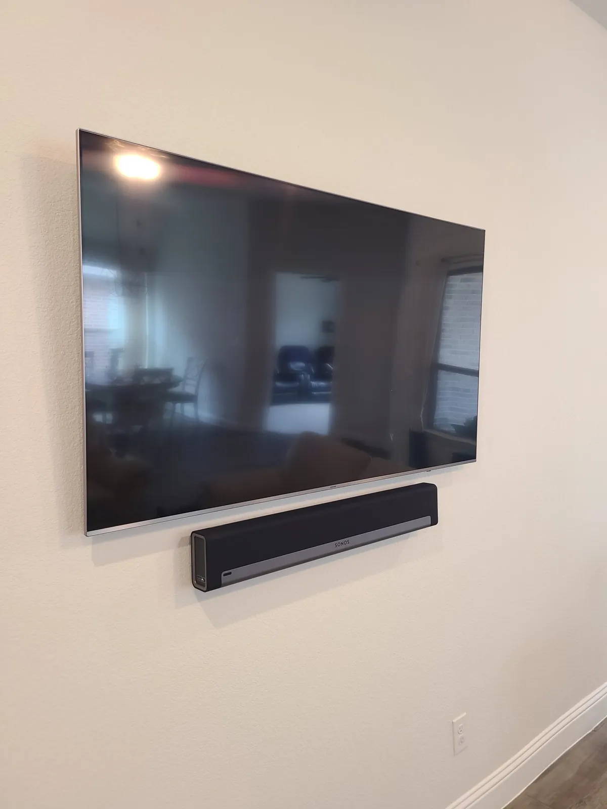 Wall-mounted TV with a soundbar