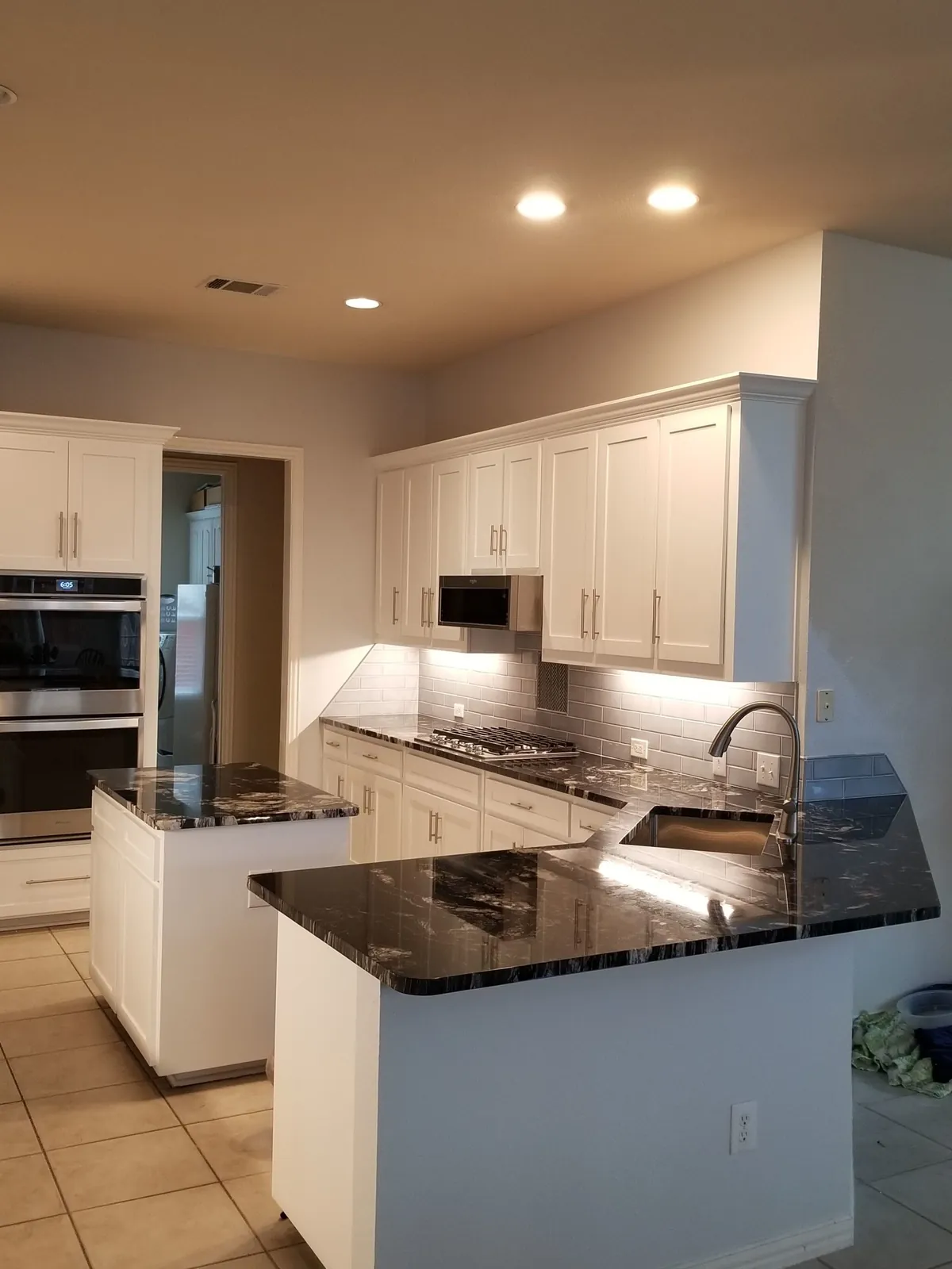 White kitchen with a dark granite island